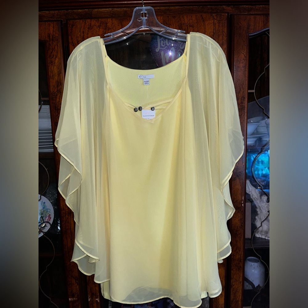 Yellow women’s blouse with breeds going across the front